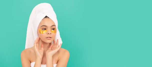 Girl with healthy skin, facial treatment, teen girl in shower towel with eye patch. Cosmetics and skin care for teenager child, poster design. Beauty kid girl banner with copy space - 写真・画像