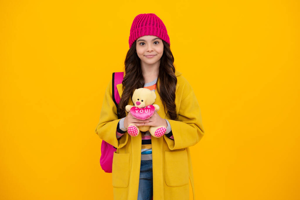 Autumn school. Funny school girl with toy isolated on yellow background. Happy childhood and kids education. Happy teenager, positive and smiling emotions of teen girl - Fotografie, Obrázek