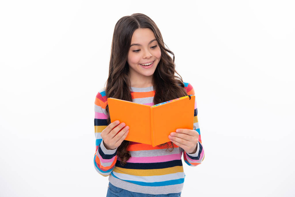 Schoolgirl with copy book posing on isolated background. Literature lesson, grammar school. Intellectual child reader. Happy girl face, positive and smiling emotions - Foto, imagen