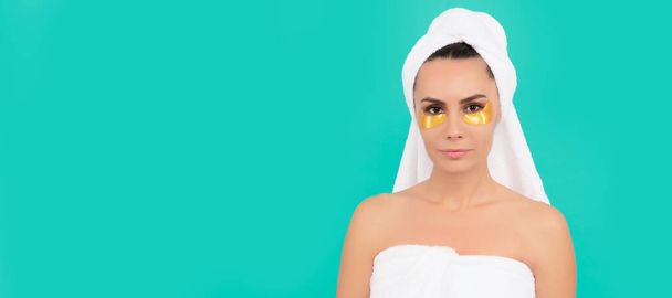 Woman isolated face portrait, banner with copy space. young woman in shower towel with golden patch - Foto, afbeelding