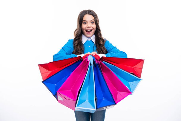 Girl teenager with shopping bags isolated on white backgound. Shopping and sale concept. Surprised emotions of young teenager girl - Fotografie, Obrázek