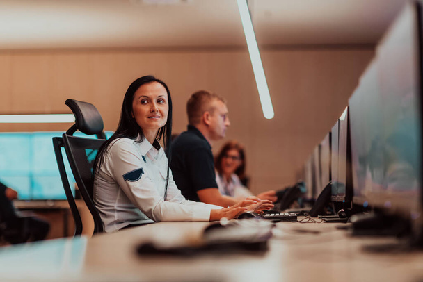 Female security operator working in a data system control room offices Technical Operator Working at the workstation with multiple displays, a security guard working on multiple monitors. High quality - Φωτογραφία, εικόνα