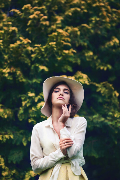 She makes a statement no matter the season. Portrait of an attractive young woman wearing a stylish hat outdoors - Fotoğraf, Görsel