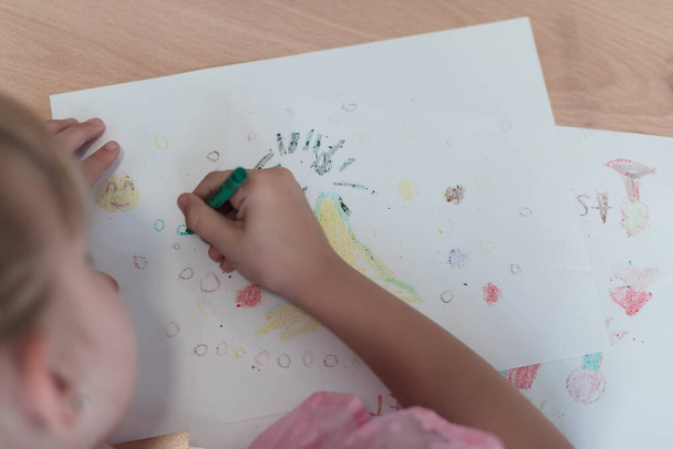 Little girls sitting in elementary school drawing on paper. High quality photo - 写真・画像