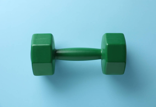 Stylish dumbbell on light blue background, top view - Photo, image