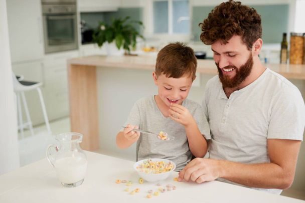 Breakfast is a time to bond. an adorable little boy and his father having breakfast together at home - Photo, Image