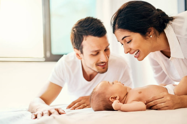Babies fill the world with love. a happy mother and father bonding with their baby boy at home - Photo, image