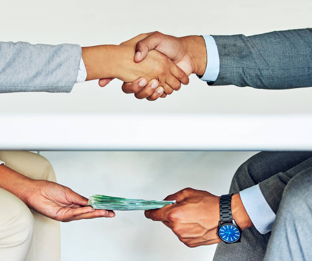 . Bribe, illegal deal and money laundering businessmen doing handshake agreement during corrupt business meeting or unethical exchange. Corporate man bribing or soliciting influence with cash - Foto, imagen