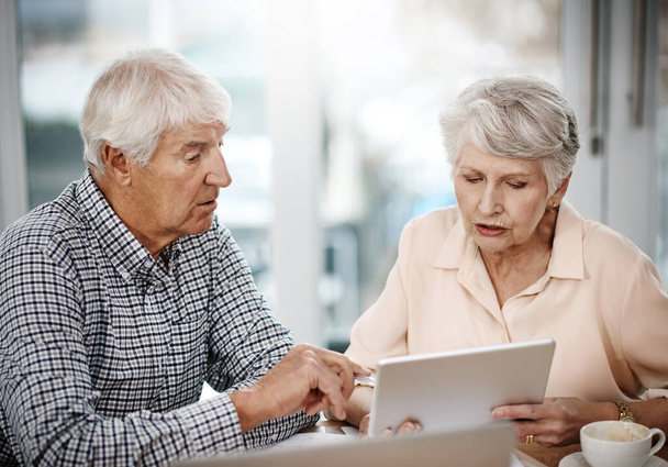 Theyre on track for a sound retirement. High angle shot of a senior couple working on their finances at home - Photo, image