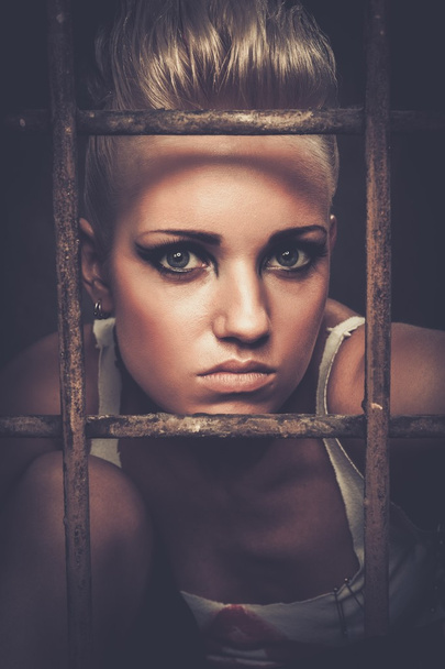 Troubled teenager girl behind bars - Foto, imagen