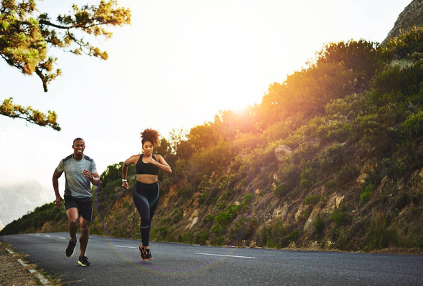 Staying healthy is a priority. a young couple out running together - Φωτογραφία, εικόνα