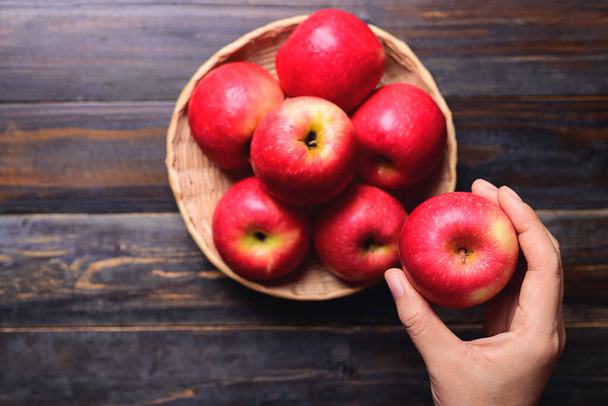 Red apple fruit holding by hand, Healthy eating, Top view - Foto, afbeelding
