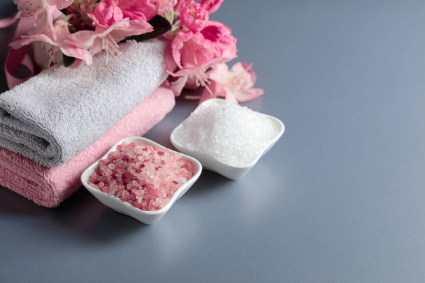 Spa composition with pink and white sea salt, flowers, and towel. Copy space. - Foto, immagini