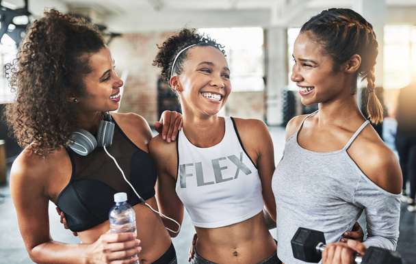 Best friends support each other to be their best. a group of happy young women enjoying their time together at the gym - Fotó, kép