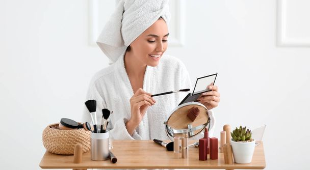 Morning of beautiful young woman applying makeup at home - Φωτογραφία, εικόνα