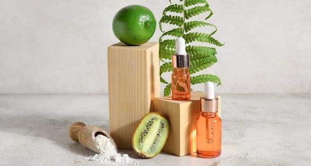 Bottles of natural cosmetics and ingredients on light background with space for text - Foto, afbeelding