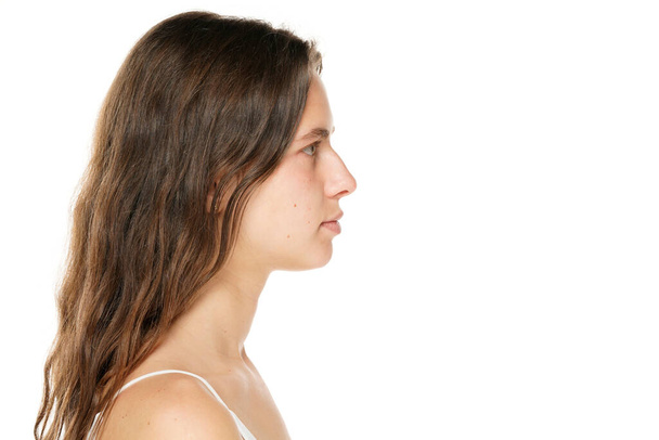 Profile of a young woman without makeup on a white background. - Foto, Imagem