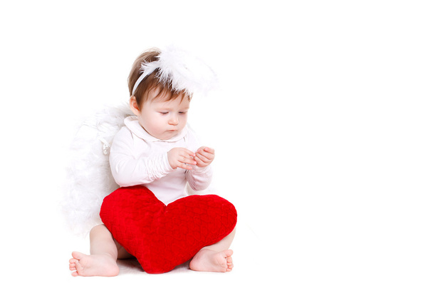 Little angel with red heart isolated on white. - Фото, изображение