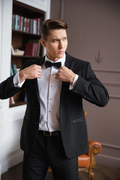 Elegant man in suit wearing jacket at home  - Foto, Imagem