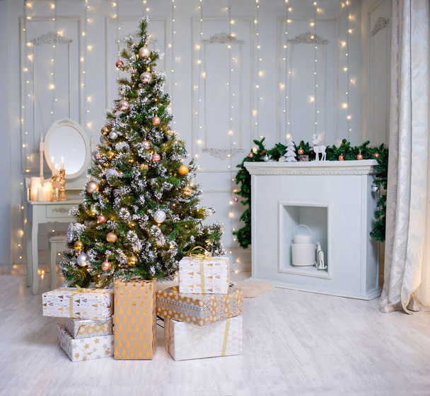 Beautiful holdiay decorated room with Christmas tree with presents under it. - Fotó, kép