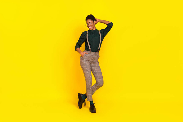 Full length body size view of attractive cheerful thin woman posing isolated over vibrant yellow color background. - Zdjęcie, obraz