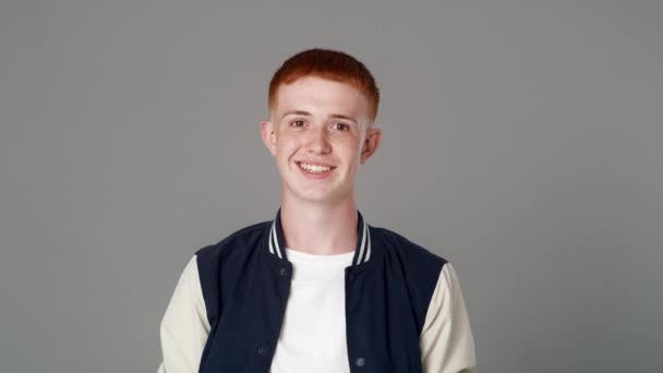 Portrait of cheerful red head caucasian teenage man with toothy smile. Shot with RED helium camera in 8K.     - Filmmaterial, Video