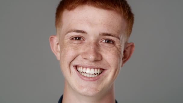 Close up portrait of red head caucasian teenage man with toothy smile. Shot with RED helium camera in 8K.  - Filmati, video
