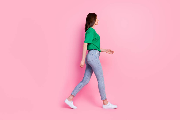 Full body photo of lovely young girl walking shopping mall weekend promo dressed trendy green clothes isolated on pink color background. - Fotoğraf, Görsel