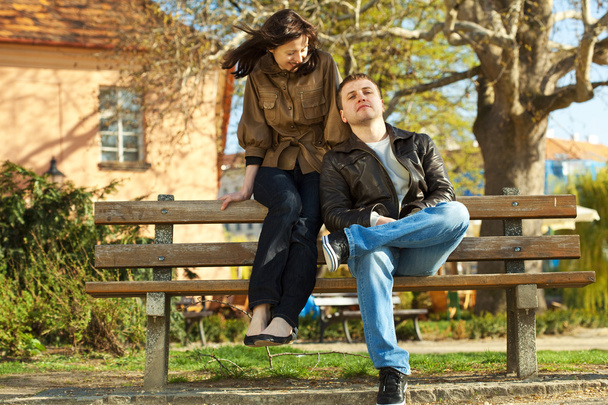Love couple sitting on a bench - Φωτογραφία, εικόνα