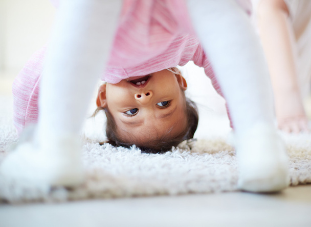 Little girl somersaulting - Photo, Image