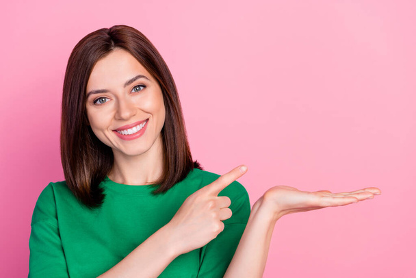 Closeup photo of young smiling woman hold hand new product advertisement recommend isolated on pink color background. - Fotó, kép