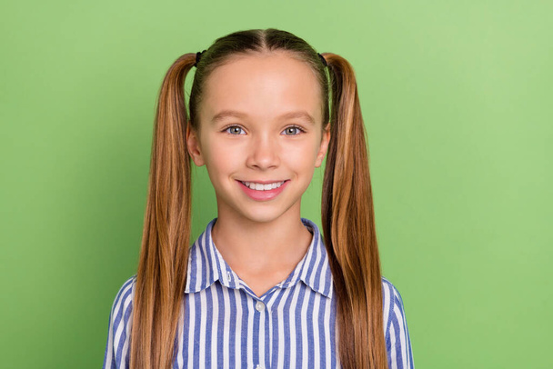 Photo of shiny charming small schoolkid dressed striped uniform smiling isolated green color background. - Valokuva, kuva