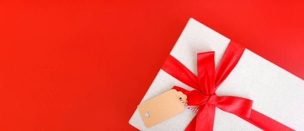 Red banner with gift box tied red ribbons.. - Foto, Bild