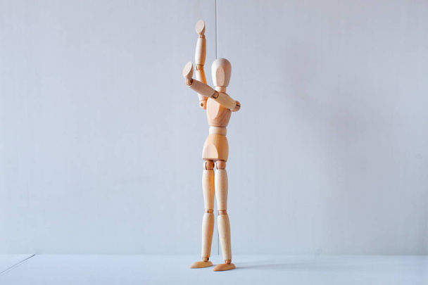 Concept of making the stop signal with the figure of a wooden boy - Foto, Bild