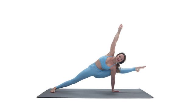 Young athletic attractive woman practicing yoga isolated on whit - Photo, image