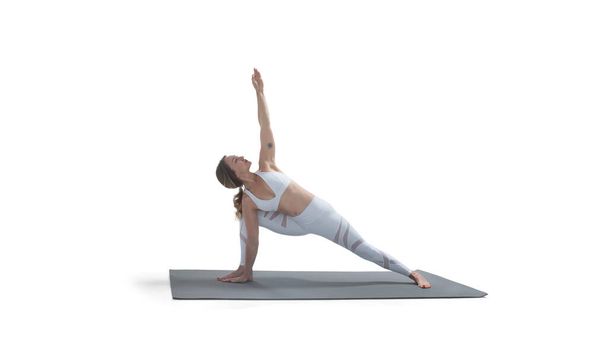 Young athletic attractive woman practicing yoga isolated on white. - 写真・画像
