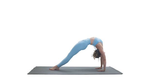 Young athletic attractive woman practicing yoga isolated on whit - Foto, afbeelding