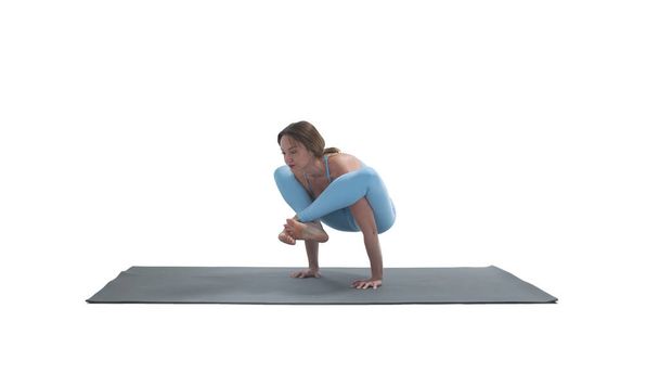Young athletic attractive woman practicing yoga isolated on whit - Zdjęcie, obraz