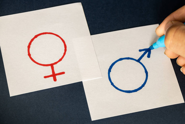 hand-painted on white pages symbols of gender, Woman and man, symbol of equality - Foto, afbeelding