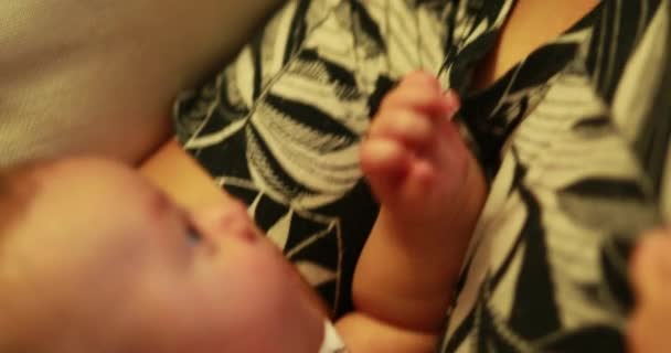 Candid moment between mom and newborn baby in evening mother smiling with infant - Filmagem, Vídeo