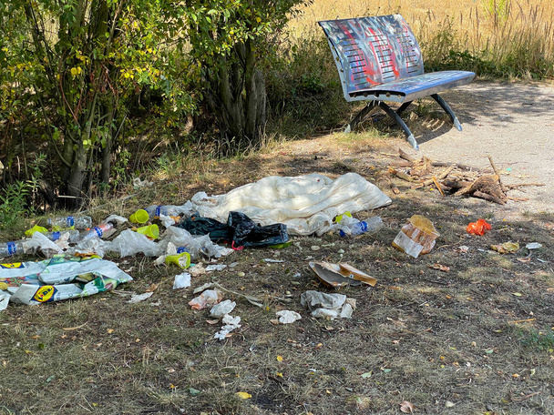 Littered park. Scattered trash. Littering garbage nature. Ecology. - Photo, image