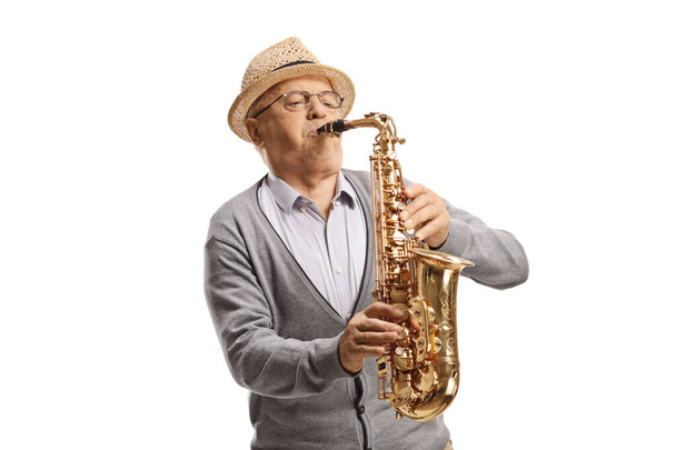 Senior male musisican playing a saxophone isolated on white background - Zdjęcie, obraz