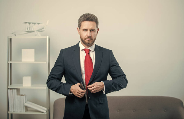 businessperson in suit at business office with phone. - Photo, image