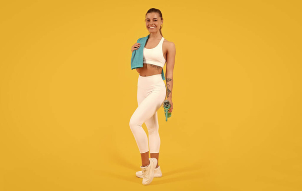 sport woman with water bottle on yellow background. - Photo, Image