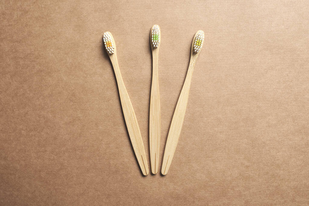 Set of three ecological bamboo toothbrushes. Concepts: sustainable lifestyle, use of compostable and environmentally friendly materials, zero plastics. Studio shot with copy space. - Zdjęcie, obraz