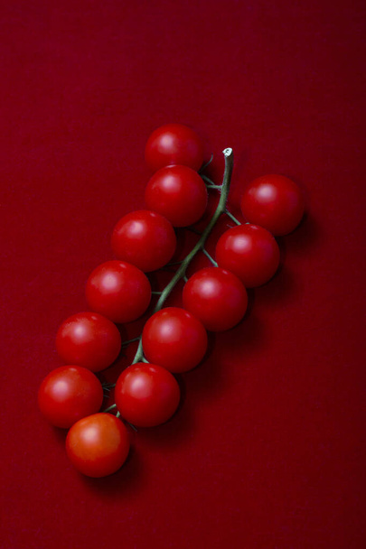Ripe red Cherry tomatoes on a red background - Foto, Imagen