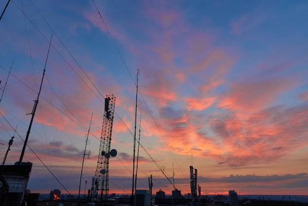 televisions antennas with sunset cloudy sky background - Photo, Image