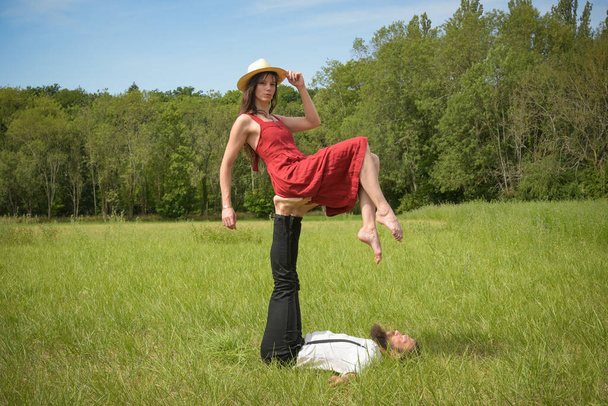caucasian couple doing stunts on a meadow in France - Fotoğraf, Görsel