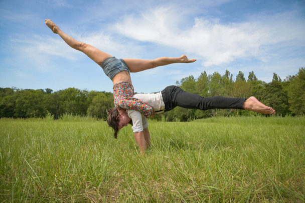 caucasian couple doing stunts on nature in France - Foto, afbeelding