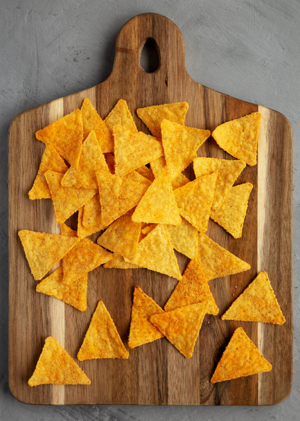 Gluten free Mexican tortilla chips with Barbecue Flavor on a wooden board, top view. Flat lay, overhead, from above. - Foto, immagini